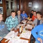 Photo of trombone students around a table at dinner during Fall 2010.
